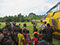 Asia - Papua New Guinea - villagers gathering around helicopter